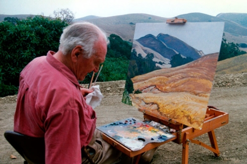 Photograph of Ray Strong (1905-2006) painting a landscape at an easel